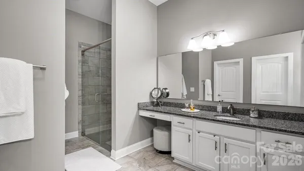a bathroom with double sink and a mirror