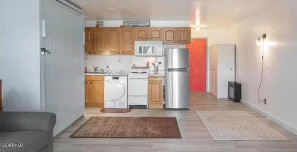a kitchen with stainless steel appliances granite countertop a refrigerator and a stove