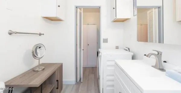 a bathroom with a sink a mirror and a shower