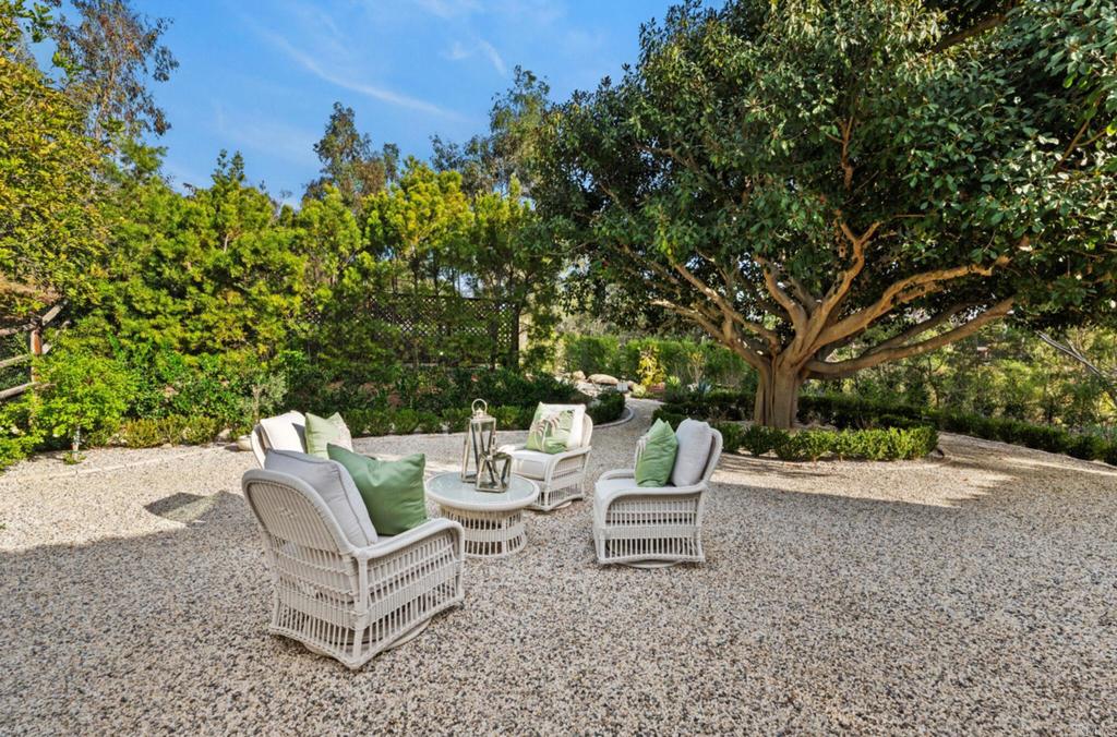 5315 La Crescenta Road Rancho Santa Fe, CA 92067 - Photo 21 of 34 a view of a chairs and bench in a backyard