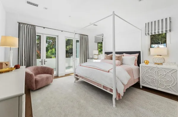 a bed room with a bed and a potted plant