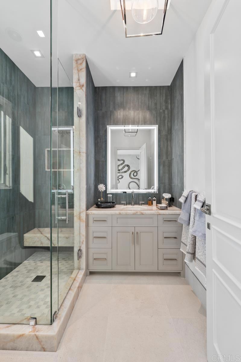 5315 La Crescenta Road Rancho Santa Fe, CA 92067 - Photo 23 of 34 a large bathroom with a granite countertop sink mirror and a bath tub