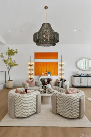 a living room with couches and a potted plant