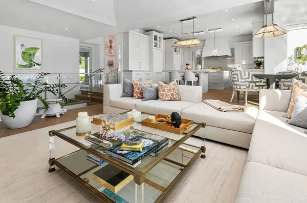 a living room with furniture and a chandelier