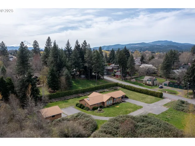 a backyard of a house with yard basket ball court and outdoor seating