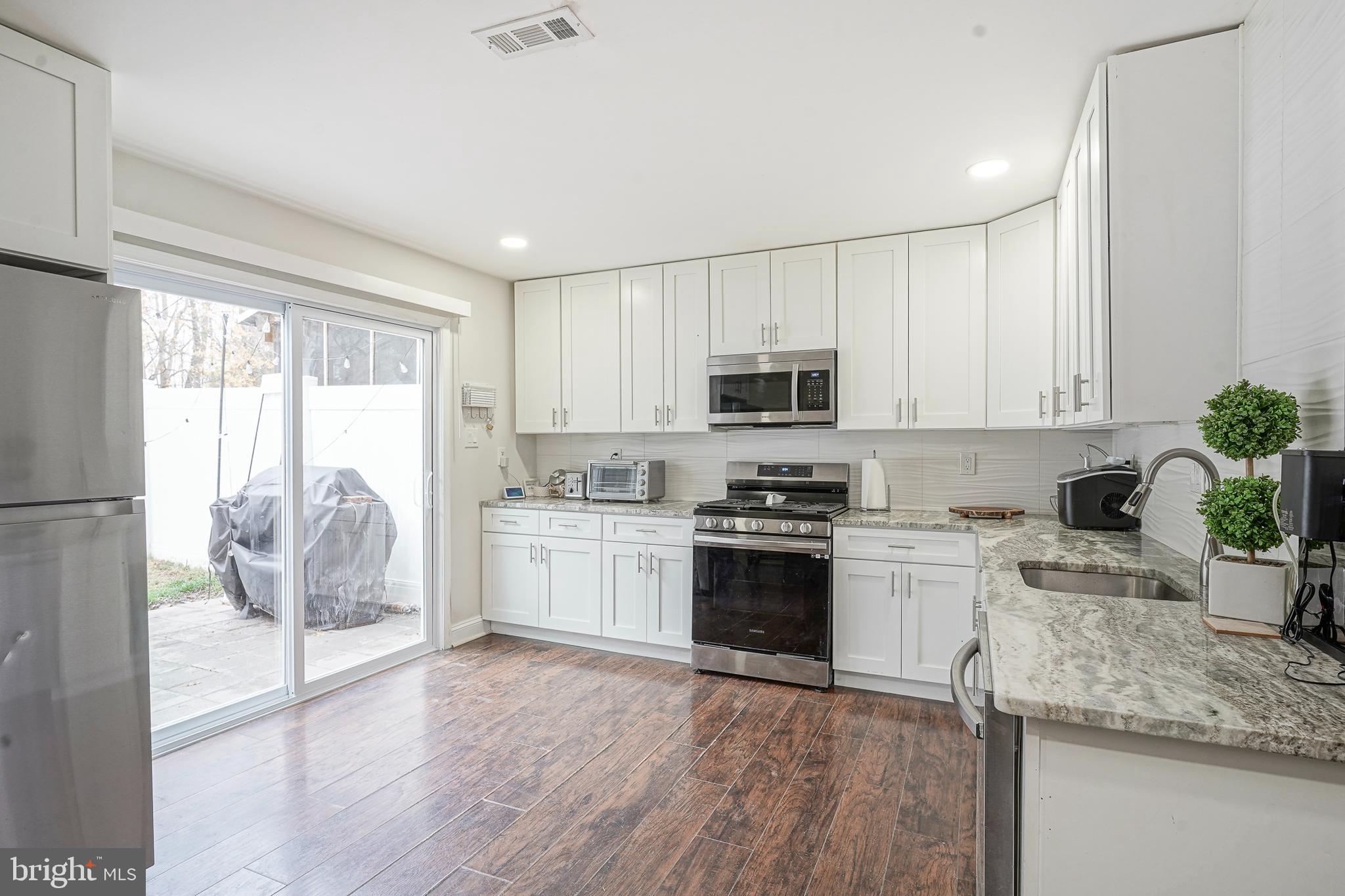 48 Memphis Court Sicklerville, NJ 08081 - Photo 9 of 28 a kitchen with granite countertop a stove top oven sink and cabinets