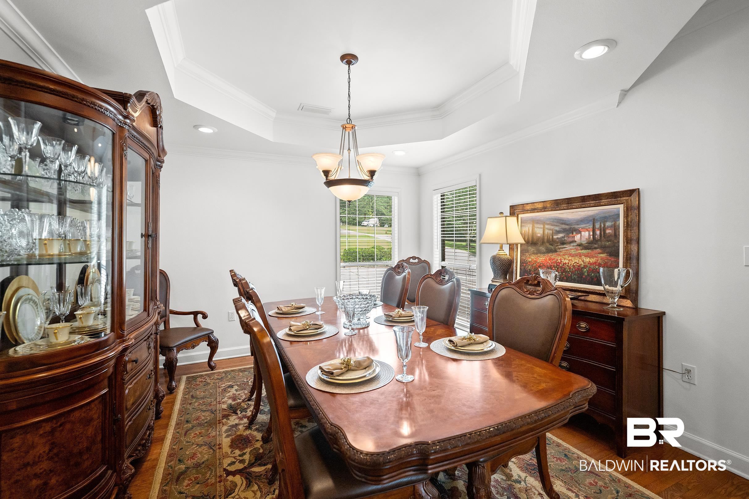 197 Morning Ridge Road Monroeville, AL 36460 - Photo 22 of 51 Dining area featuring a tray ceiling with recessed lighting and a central chandelier