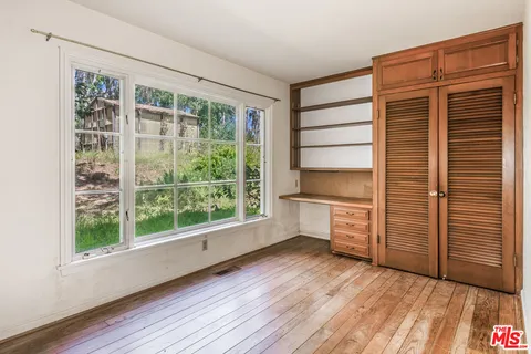 a room with a wooden floor and furniture