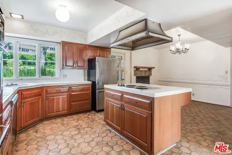 a kitchen with stainless steel appliances granite countertop a stove and a refrigerator