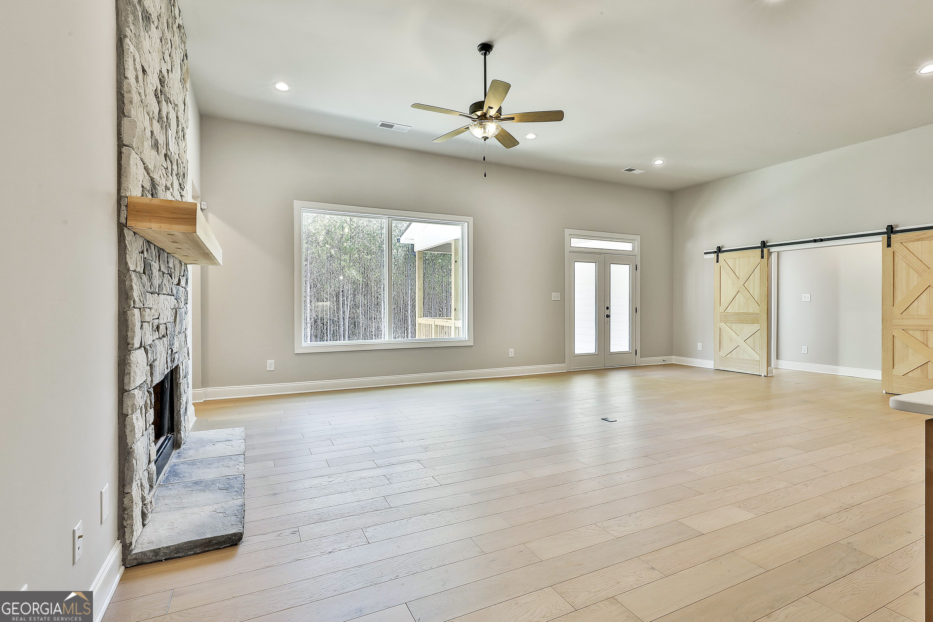 16 Nelson Way, Unit 38 Williamson, GA 30292 - Photo 12 of 44 a view of an empty room with a window and wooden floor