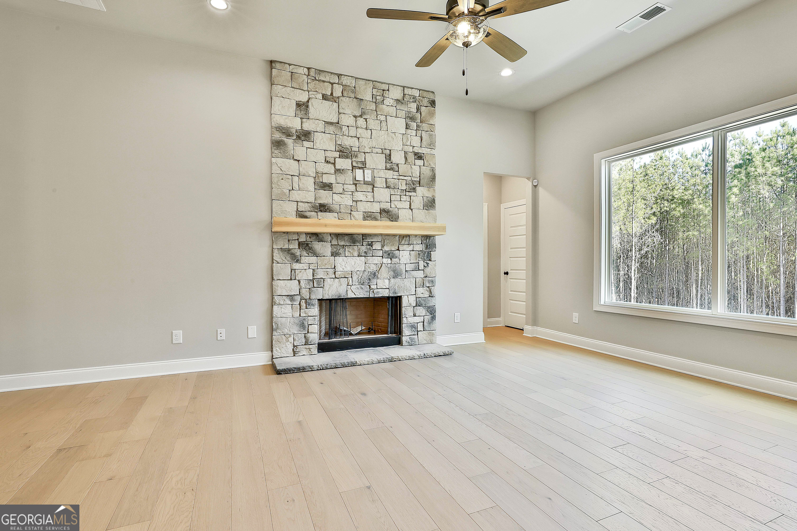 16 Nelson Way, Unit 38 Williamson, GA 30292 - Photo 14 of 44 a view of an empty room with a fireplace and a window