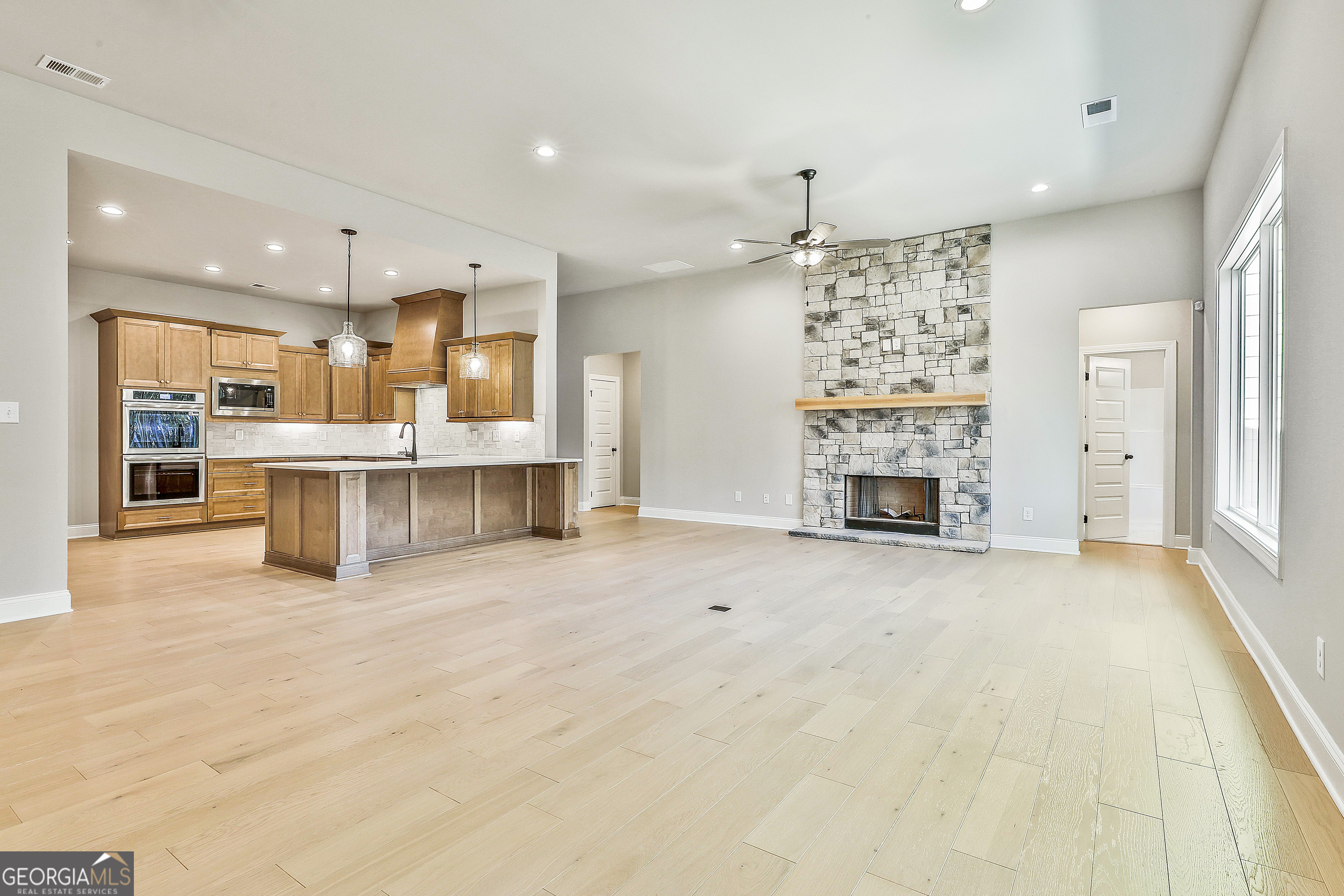 16 Nelson Way, Unit 38 Williamson, GA 30292 - Photo 15 of 44 a view of kitchen with furniture and a fireplace