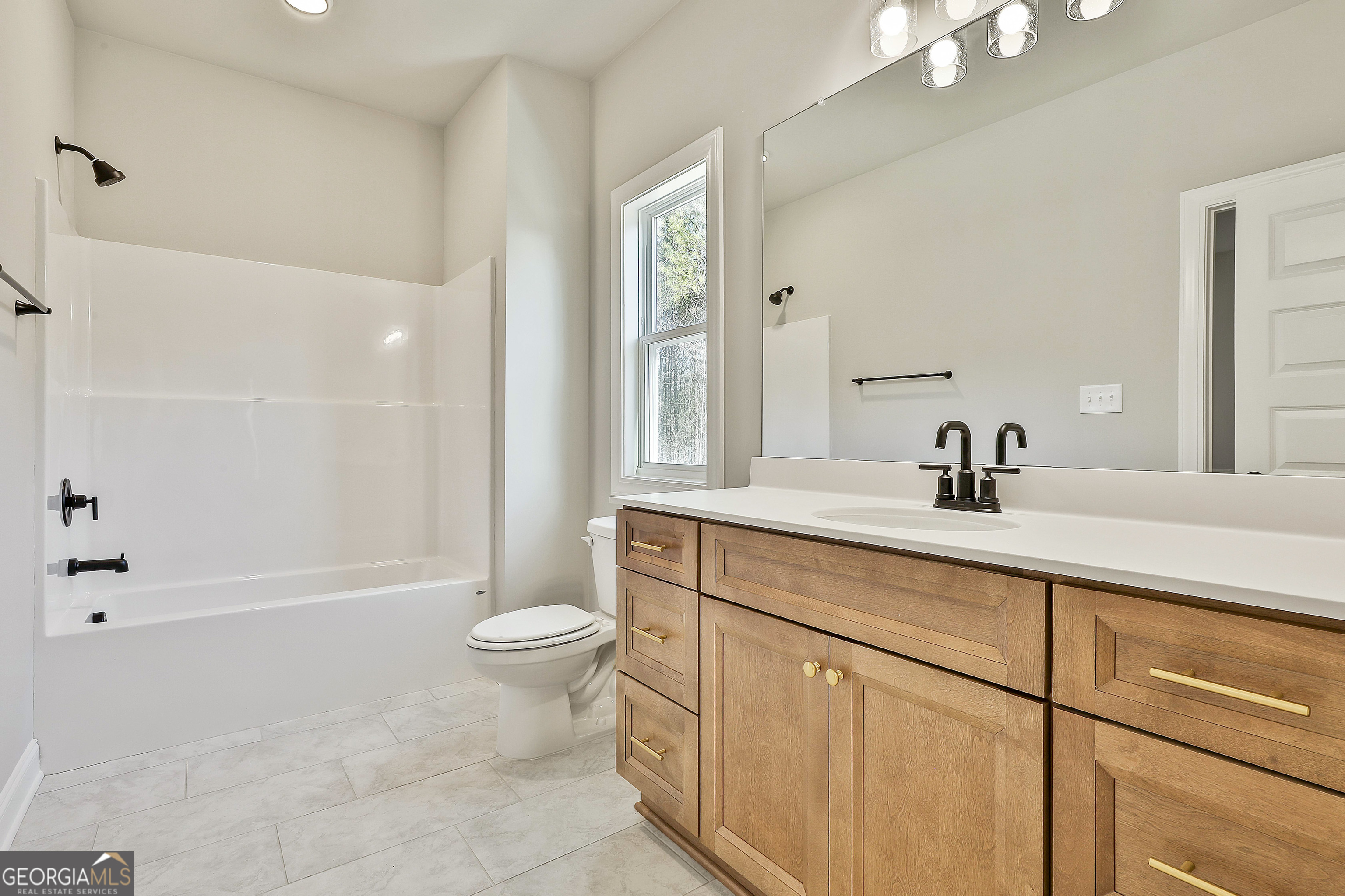 16 Nelson Way, Unit 38 Williamson, GA 30292 - Photo 16 of 44 a bathroom with a sink a toilet and shower