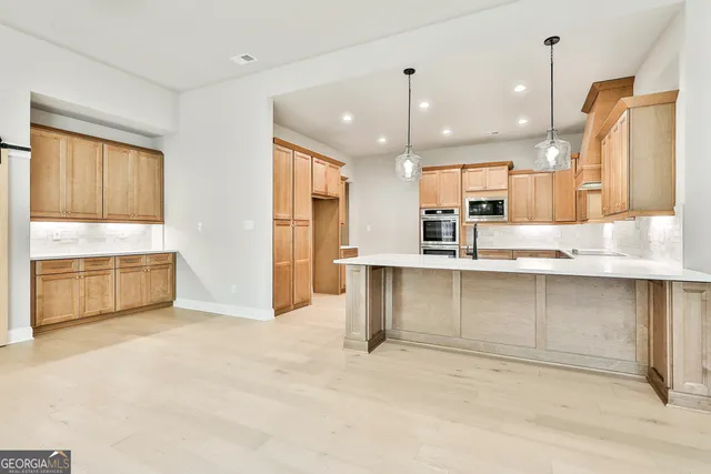 a view of a kitchen with an empty space and a window
