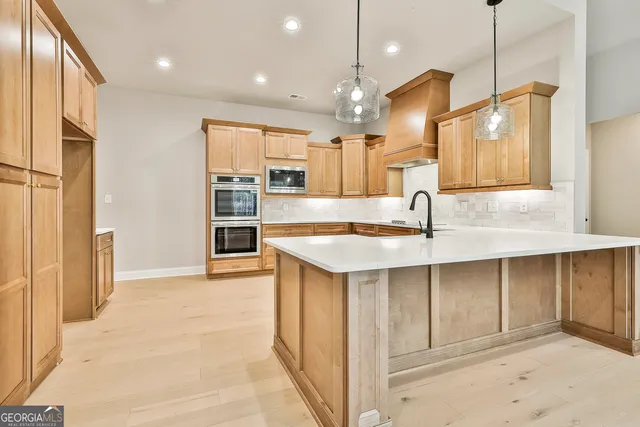 a kitchen with stainless steel appliances granite countertop a sink and cabinets