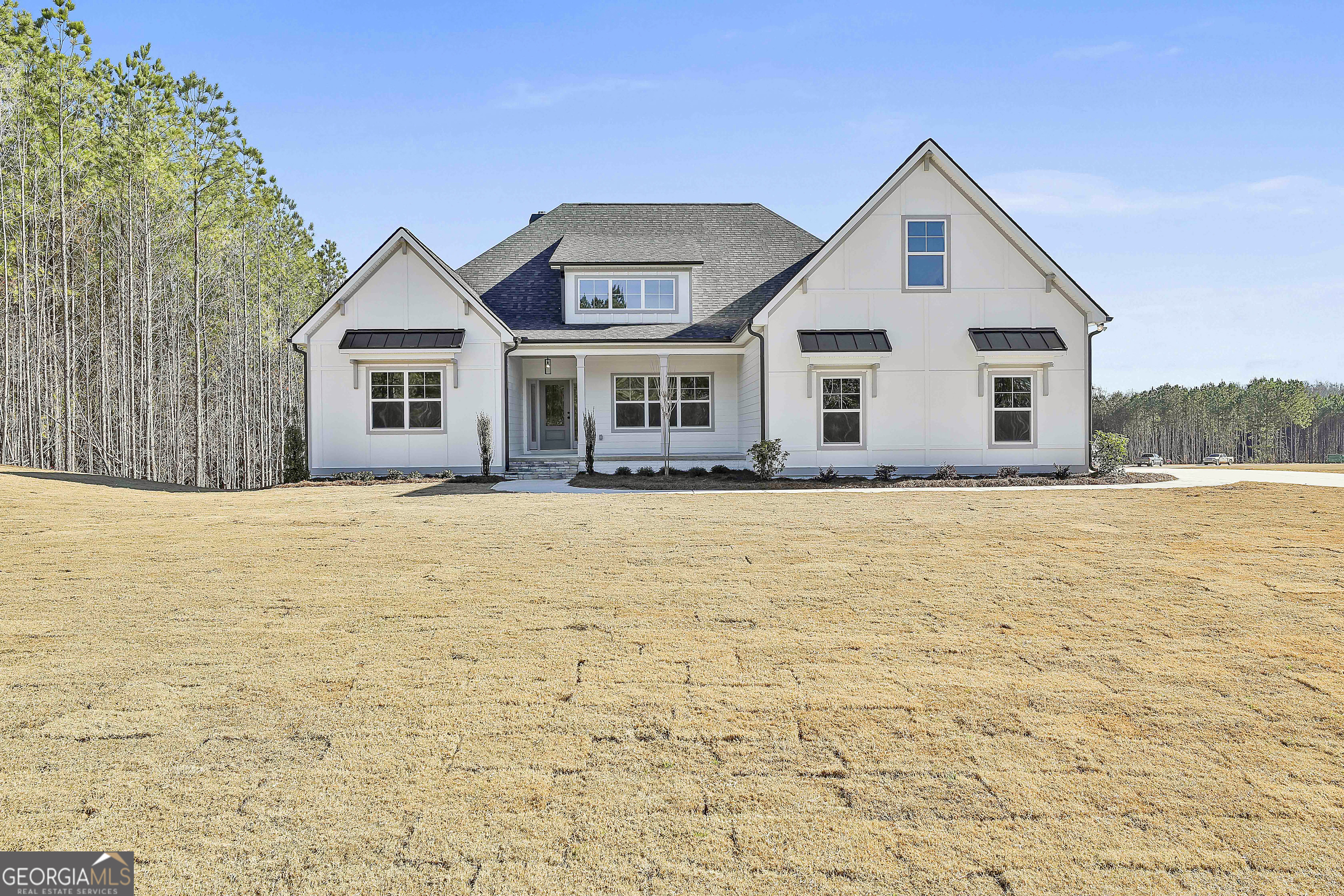 16 Nelson Way, Unit 38 Williamson, GA 30292 - Photo 2 of 44 a front view of house with yard and trees around