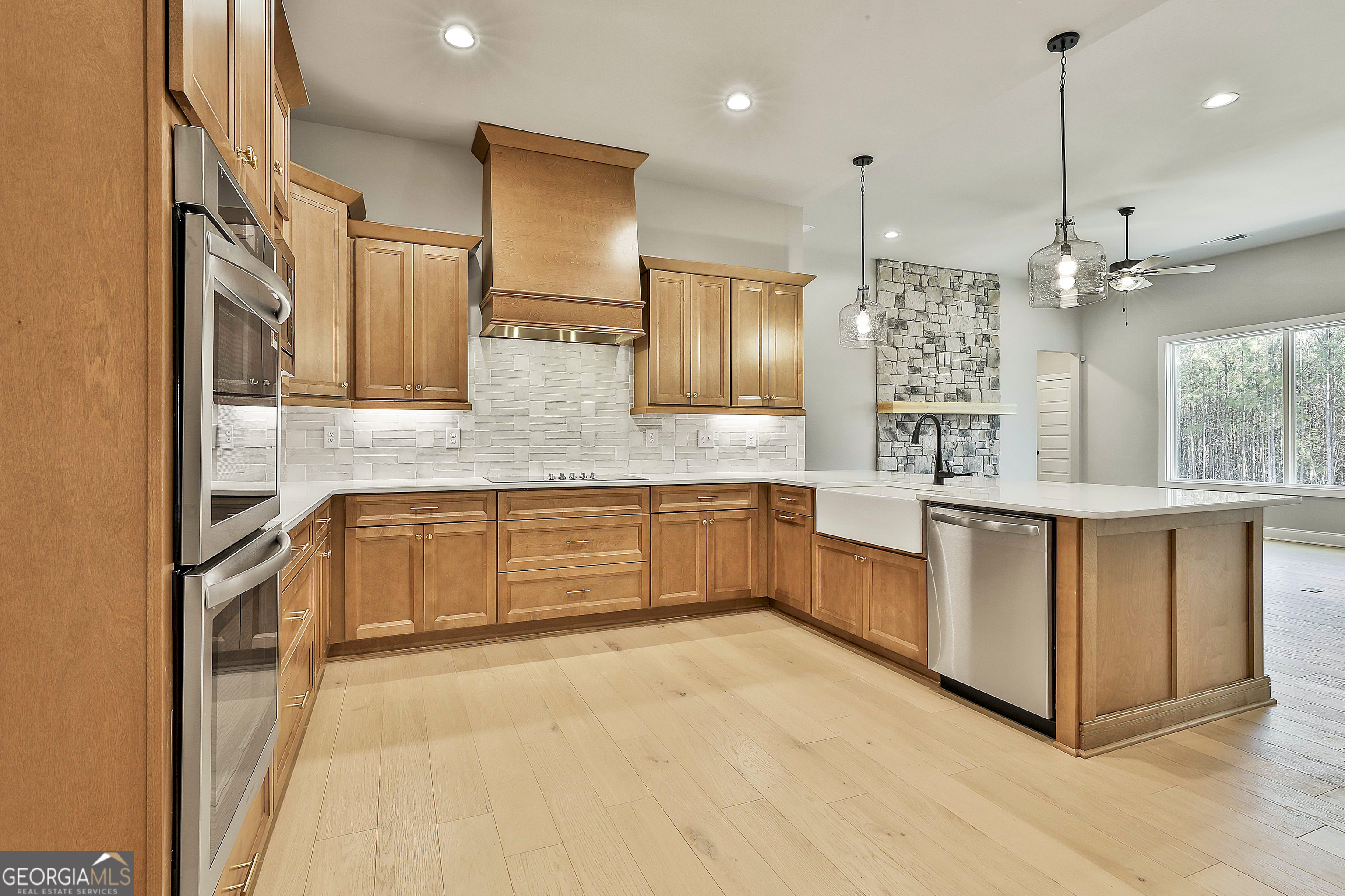 16 Nelson Way, Unit 38 Williamson, GA 30292 - Photo 22 of 44 a large kitchen with granite countertop a large counter top stainless steel appliances and cabinets