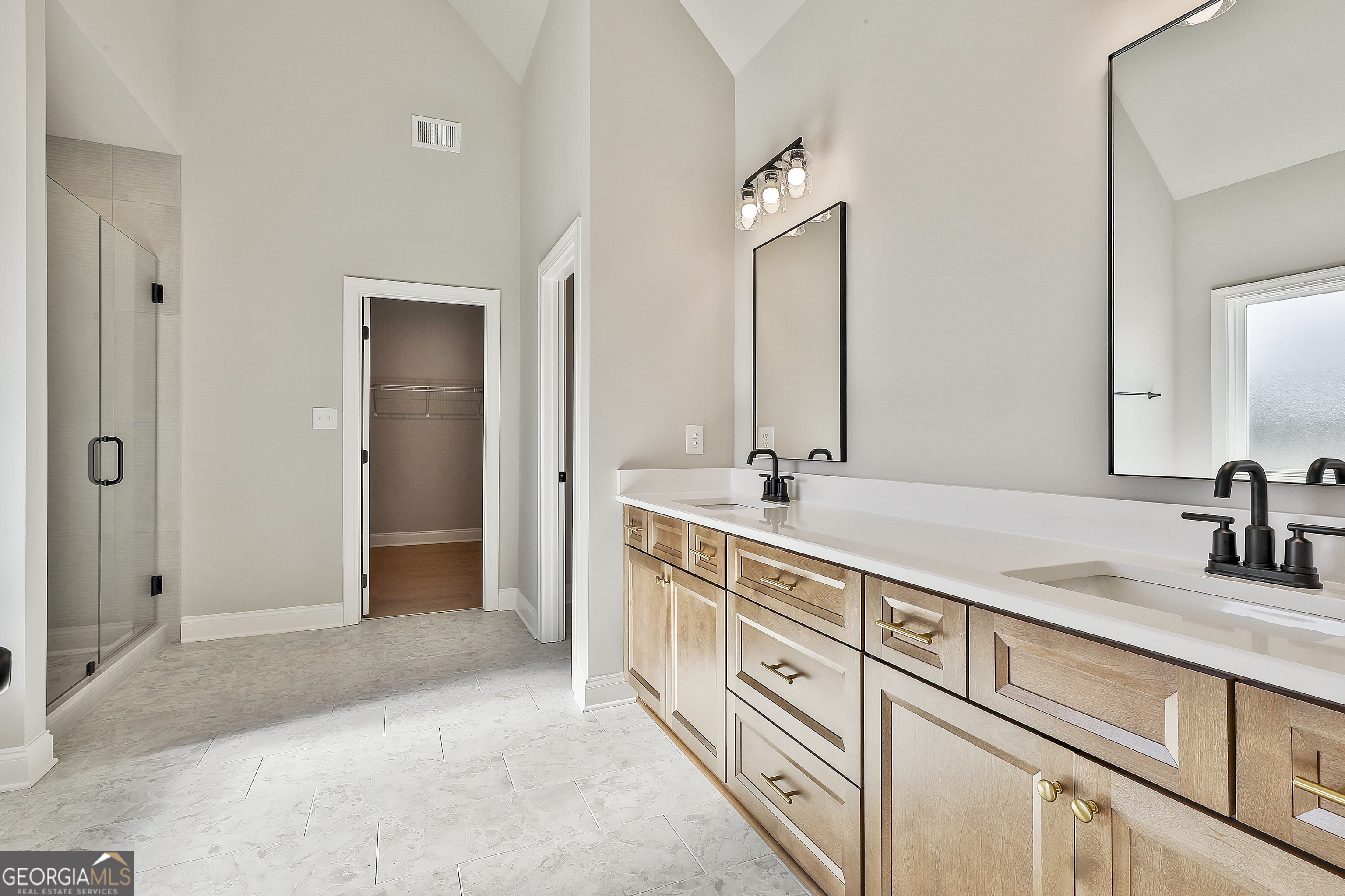 16 Nelson Way, Unit 38 Williamson, GA 30292 - Photo 29 of 44 a bathroom with double sink and a mirror