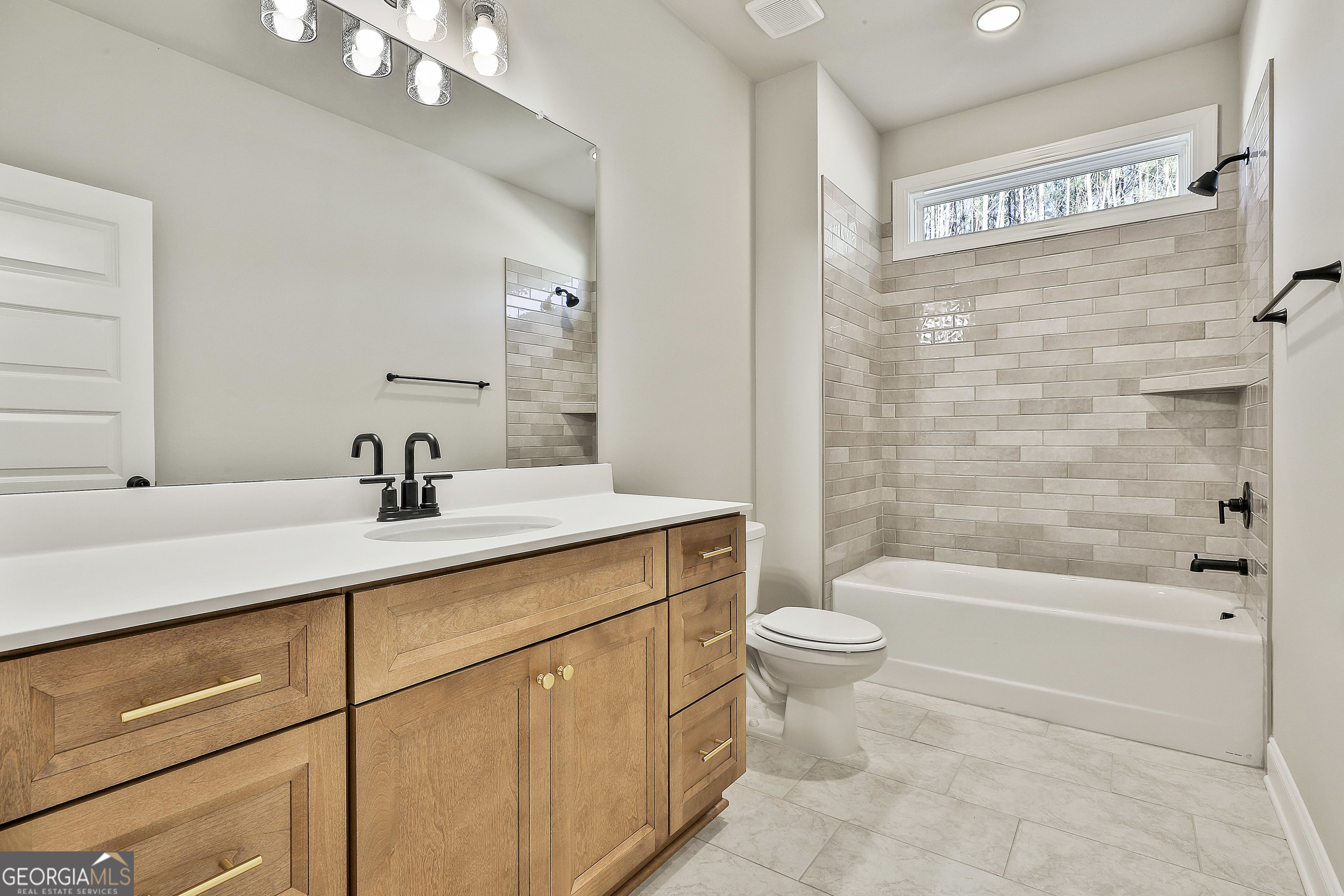 16 Nelson Way, Unit 38 Williamson, GA 30292 - Photo 34 of 44 a bathroom with a double vanity sink toilet and shower