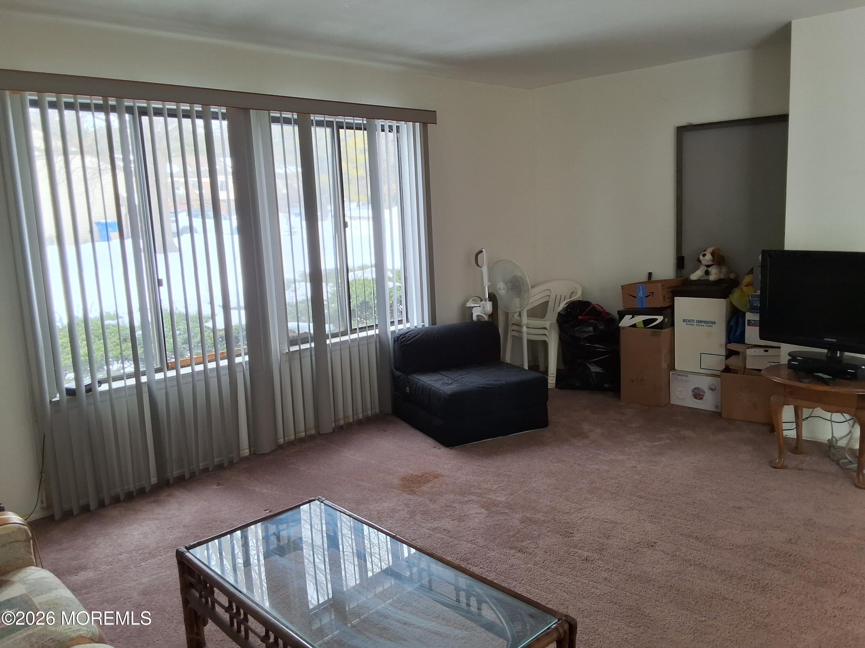 12 Coventry Court, Unit 12 Matawan, NJ 07747 - Photo 11 of 21 a living room with furniture and a flat screen tv