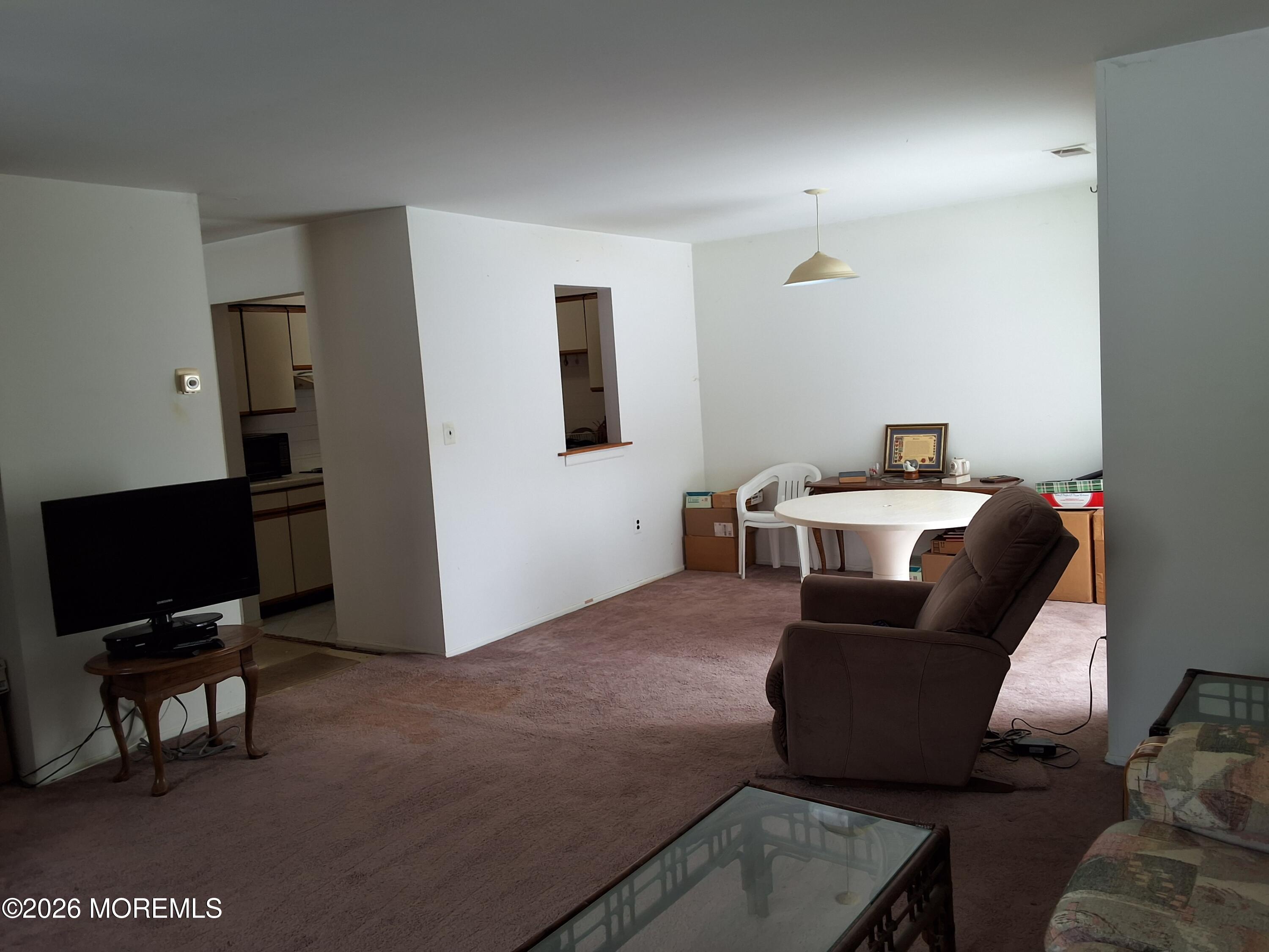 12 Coventry Court, Unit 12 Matawan, NJ 07747 - Photo 12 of 21 a living room with furniture and a flat screen tv