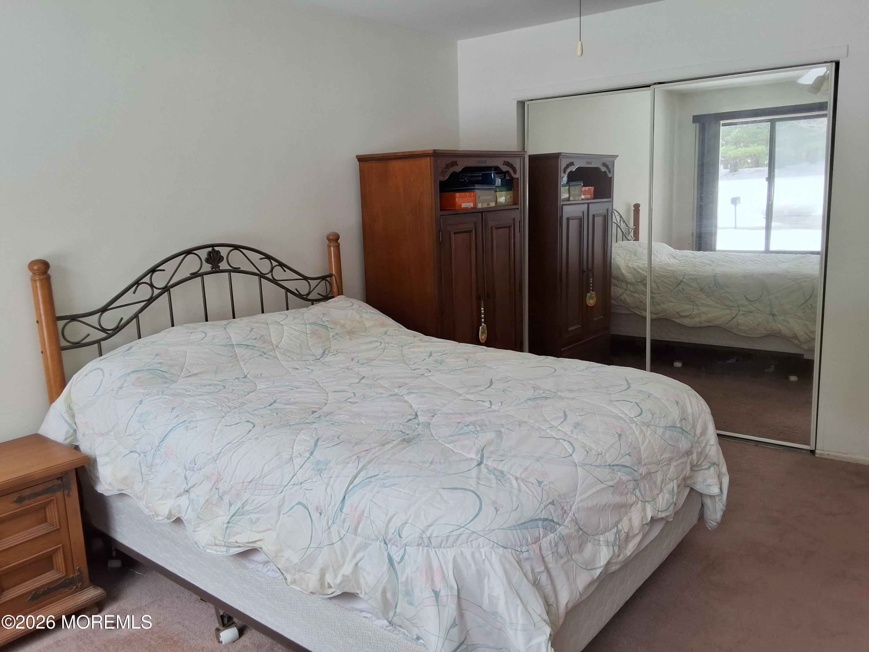 12 Coventry Court, Unit 12 Matawan, NJ 07747 - Photo 17 of 21 a large bed sitting in a bedroom next to a window