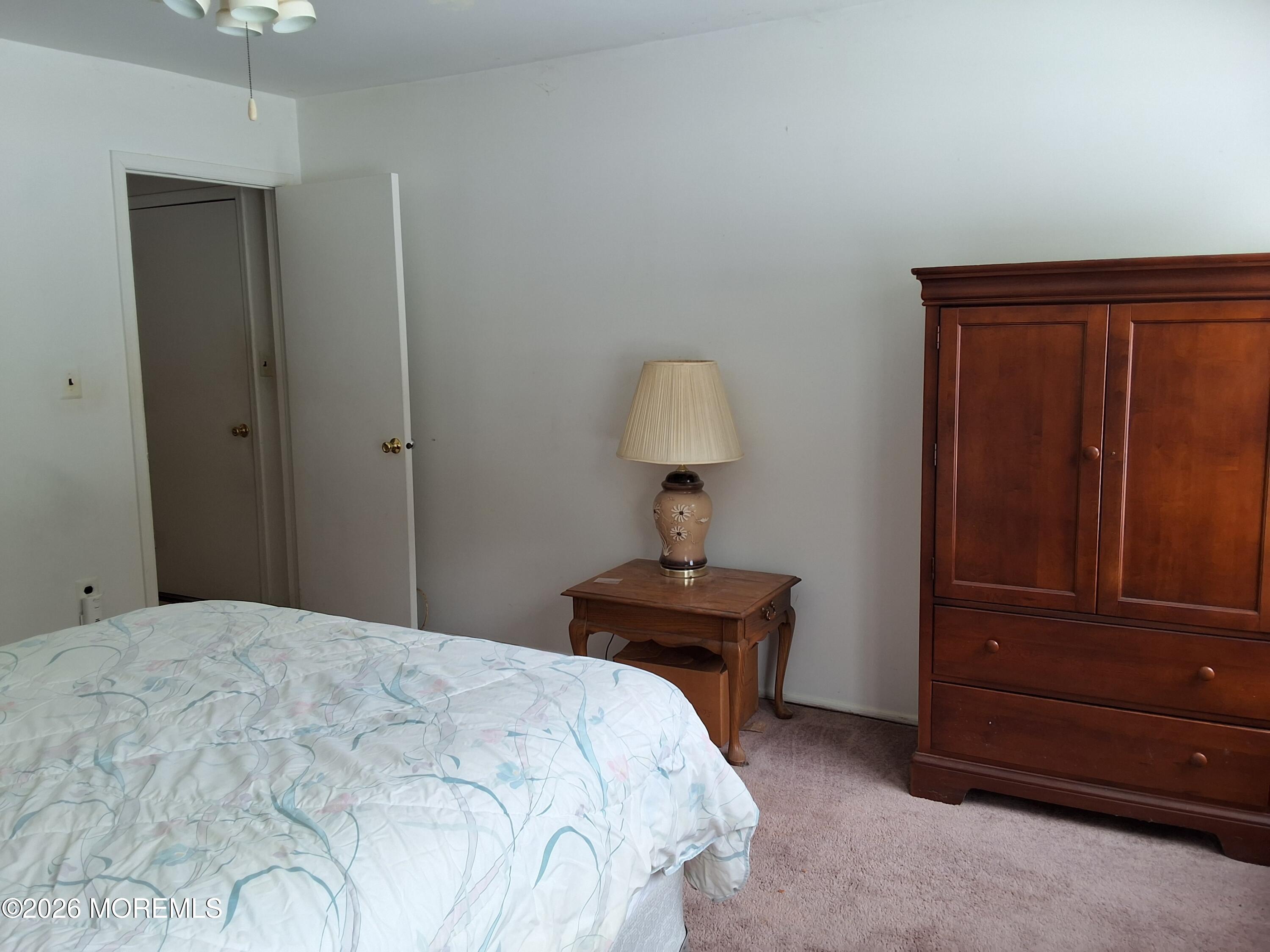 12 Coventry Court, Unit 12 Matawan, NJ 07747 - Photo 18 of 21 a bedroom with a bed and a table