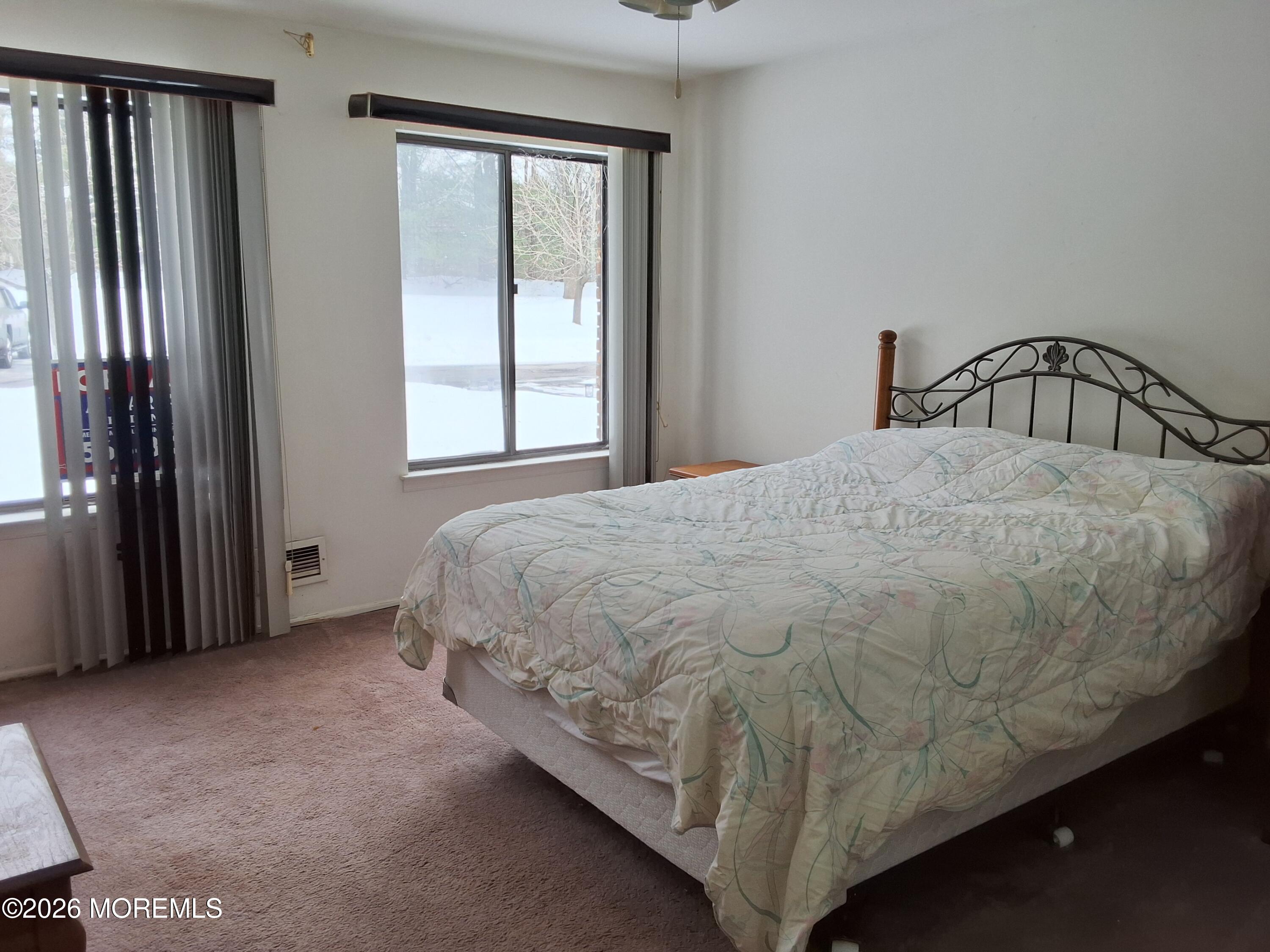 12 Coventry Court, Unit 12 Matawan, NJ 07747 - Photo 20 of 21 a bed sitting in a bedroom next to a window