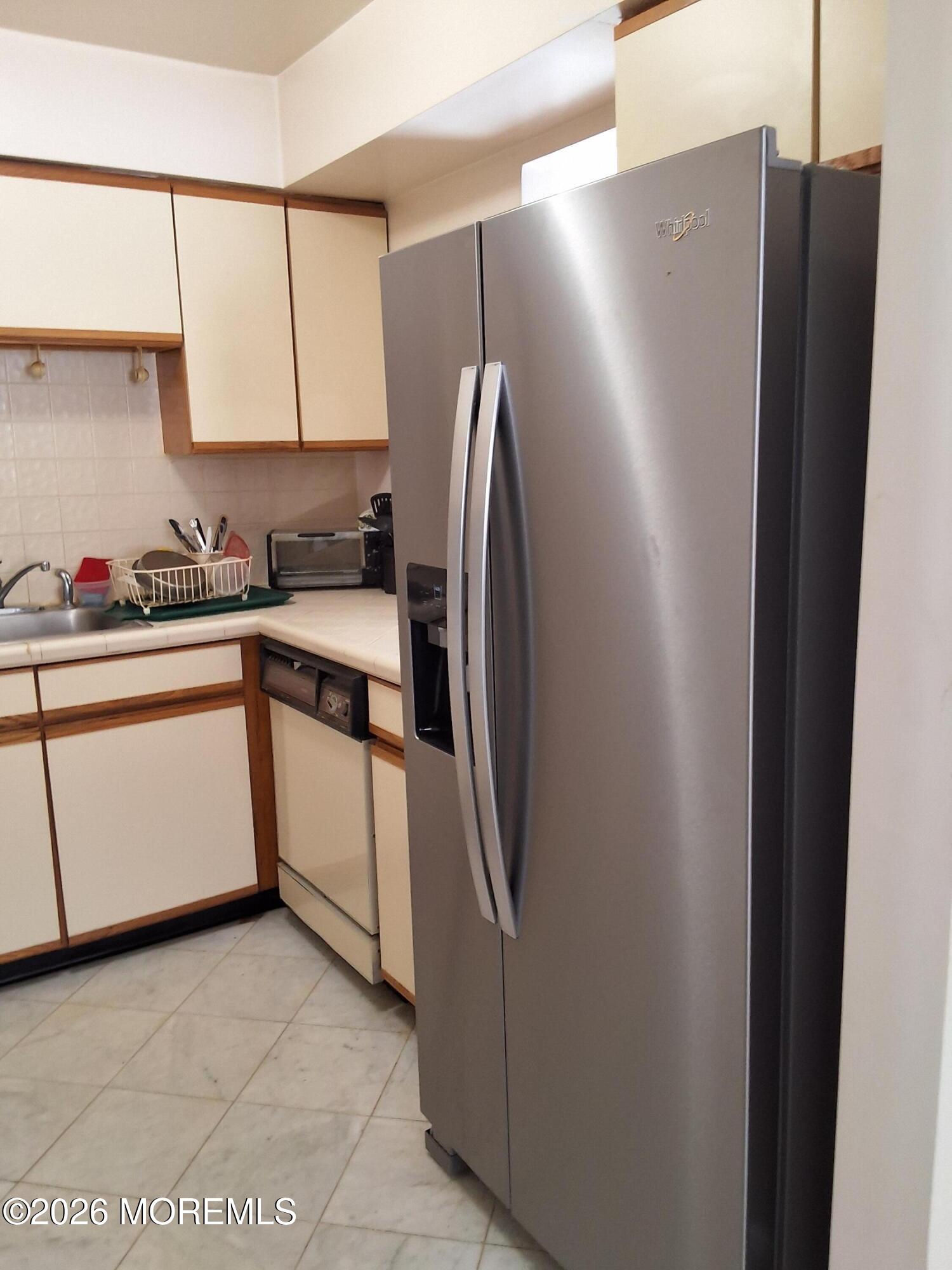 12 Coventry Court, Unit 12 Matawan, NJ 07747 - Photo 7 of 21 a kitchen with stainless steel appliances granite countertop a refrigerator and a sink