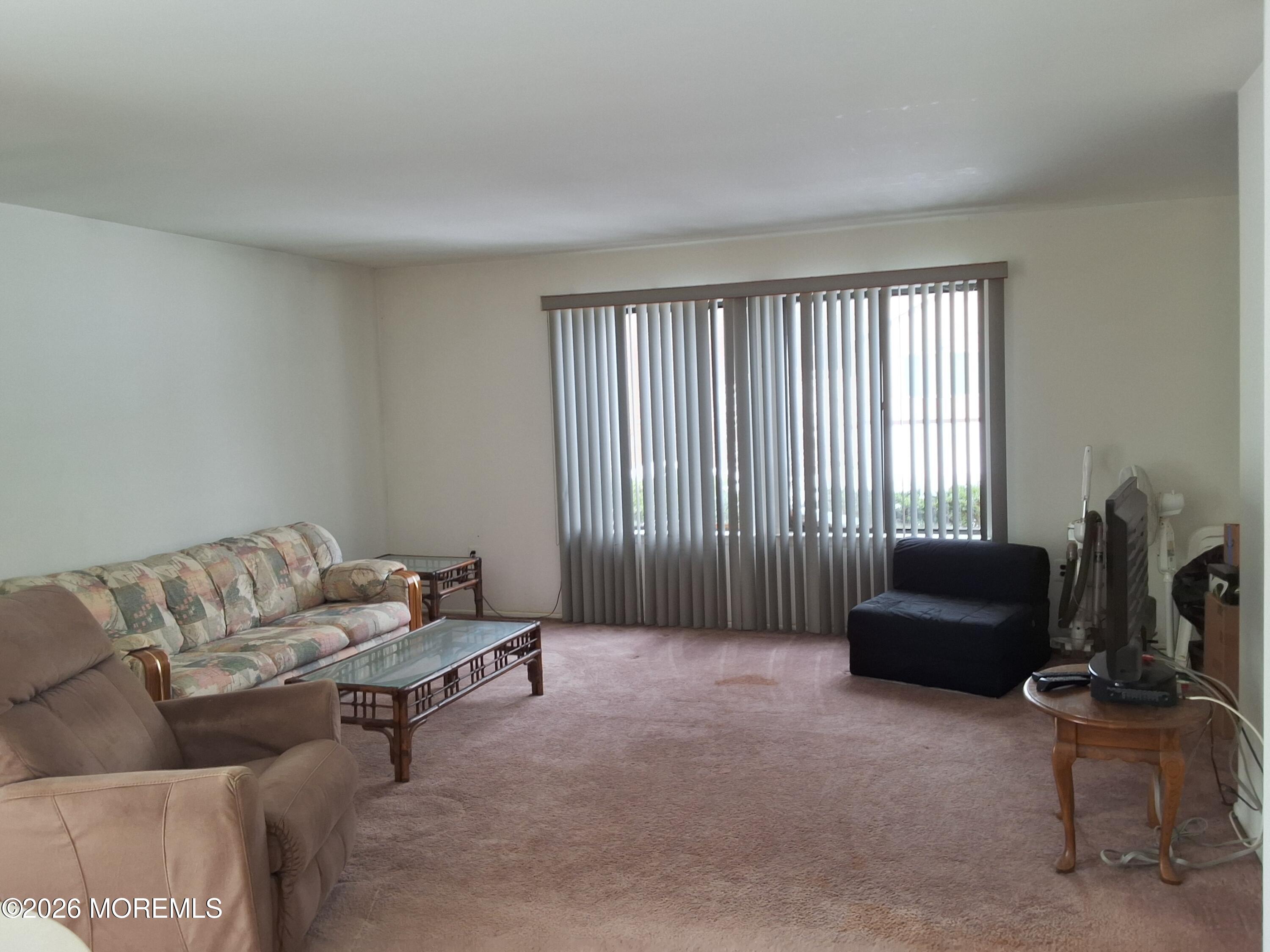 12 Coventry Court, Unit 12 Matawan, NJ 07747 - Photo 9 of 21 a living room with furniture and a window