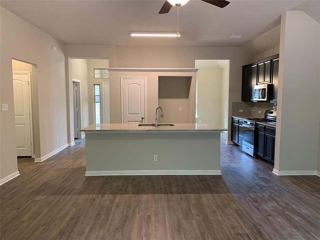 994 Arbor Crossing Conroe, TX 77303 - Photo 9 of 9 a view of kitchen with granite countertop wooden floor stainless steel appliances and a window