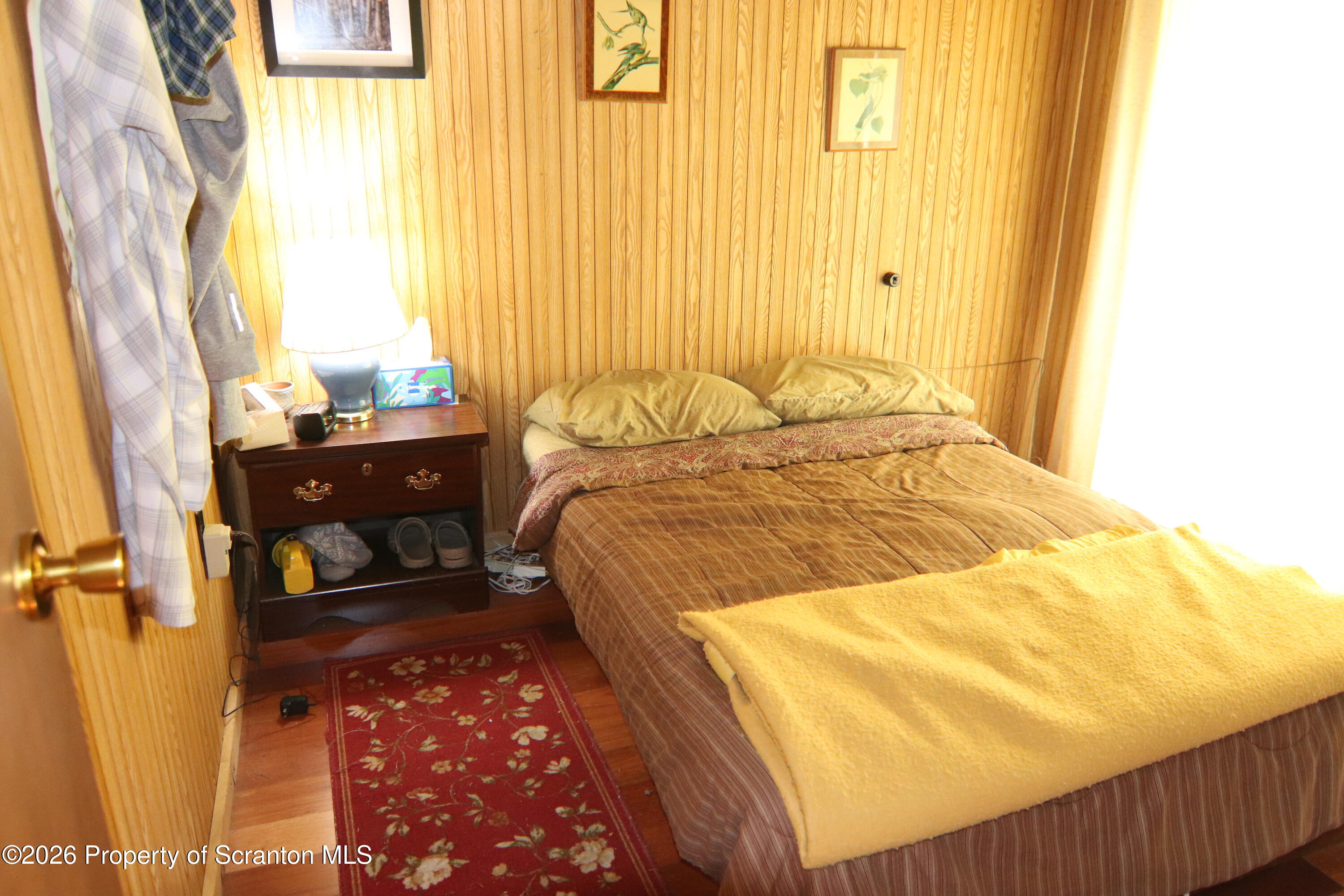 300 Pennsworth Hill Road Meshoppen, PA 18630 - Photo 18 of 38 a bedroom with a bed and wooden floor
