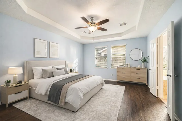 a bathroom with a tub a sink and a large mirror