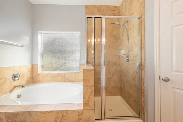 a bathroom with a tub and shower