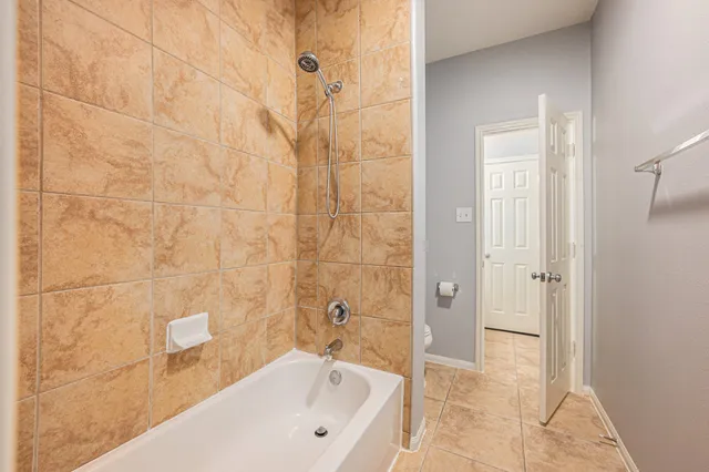 a bathroom with a bathtub and shower