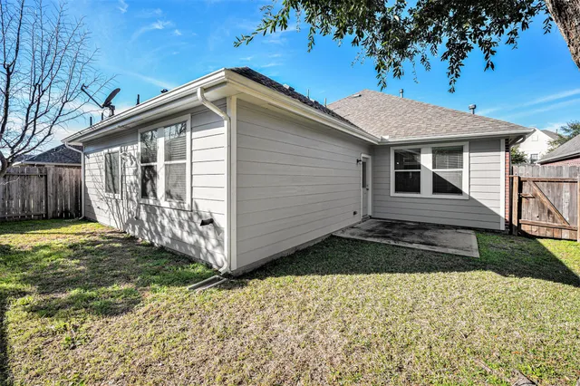 a view of a house with wooden fence