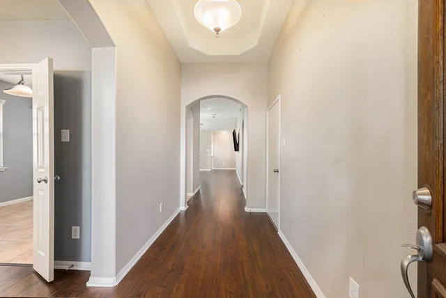 a view of a hallway with wooden floor