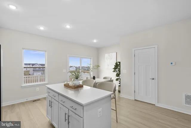 a kitchen with a sink cabinets and wooden floor