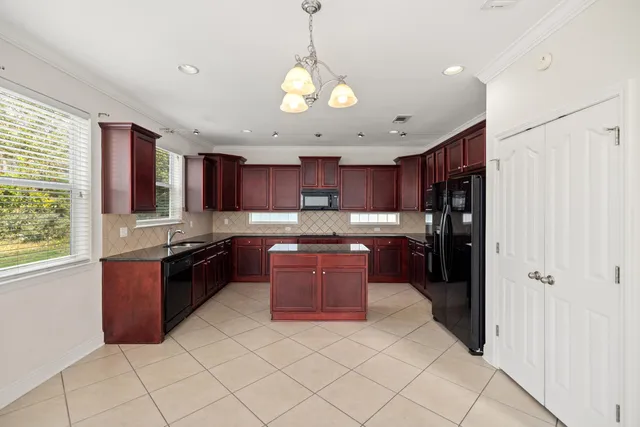 a kitchen with stainless steel appliances granite countertop a refrigerator and a stove