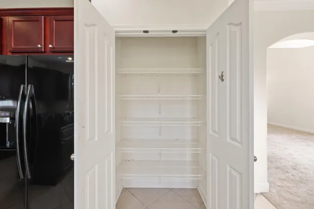 a view of walk in closet with empty racks