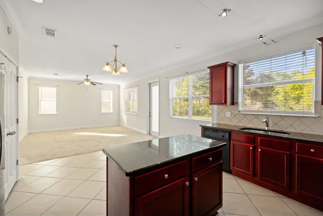 a kitchen with granite countertop a sink and cabinets