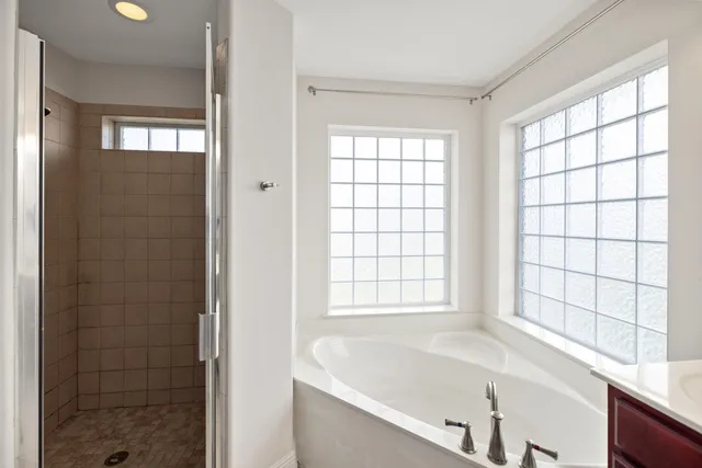 a bathroom with a bathtub and window