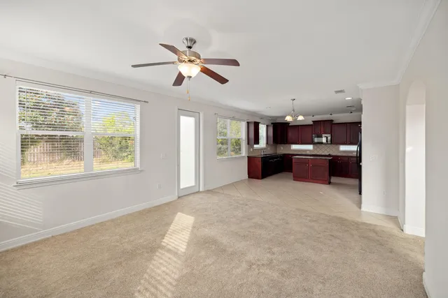 a view of a kitchen with furniture and windows
