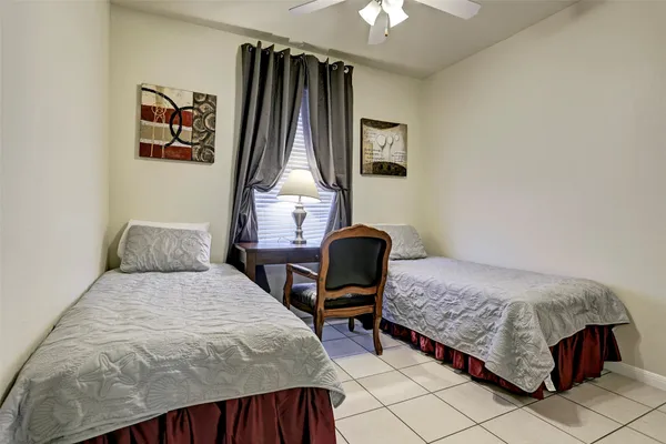 a bedroom with a bed a window and dresser