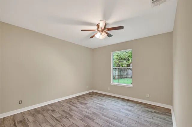 a bathroom with a granite countertop sink a toilet and a mirror