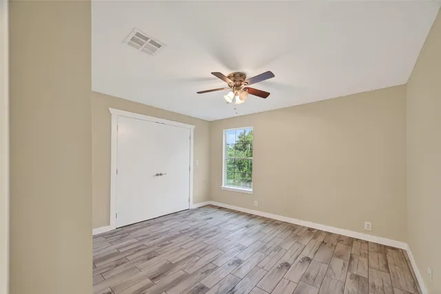 a bathroom with a granite countertop sink a toilet a mirror and bathtub