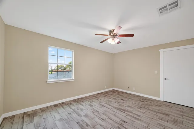 a bathroom with a granite countertop bathtub shower sink and toilet