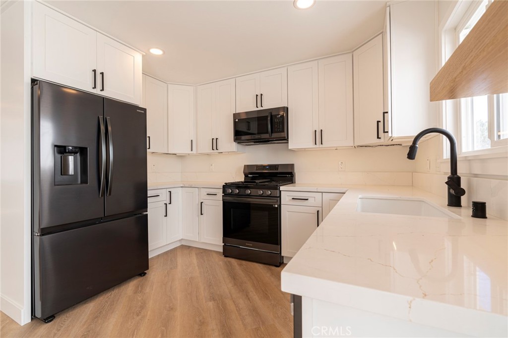 1008 Delaware Street Huntington Beach, CA 92648 - Photo 1 of 1 a kitchen with a refrigerator stove and sink