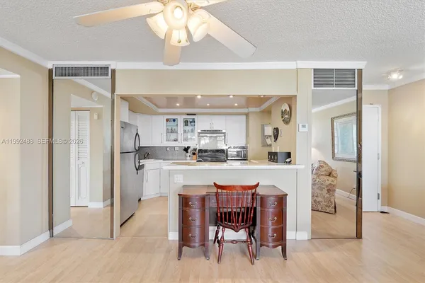 a large kitchen with a table and chairs