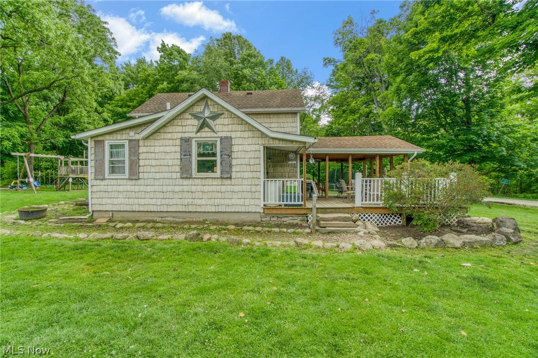 15221 Thompson Road Thompson, OH 44086 - Photo 2 of 31 View of front of house with a front yard and a deck